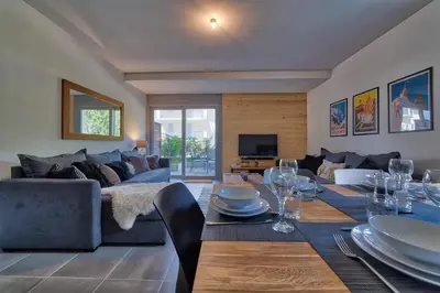 a living room with a table and a couch at Base Camp: Residence Ferme de Montenvers in Chamonix-Mont-Blanc
