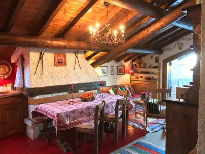 a dining room with a table and a chandelier at Appartement Hameau des Pistes - Ski-in and Ski-out in Megève