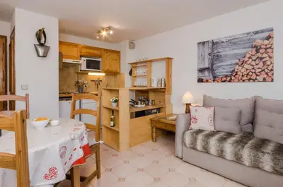 a bedroom with a large white bed with two pillows at Appartement Le Chamois in Megève