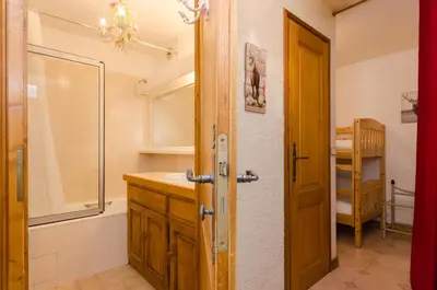 a bedroom with a white bed with towels on it at Appartement Le Chamois in Megève