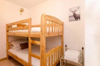 a bedroom with a large bed with towels on it at Appartement Le Chamois in Megève