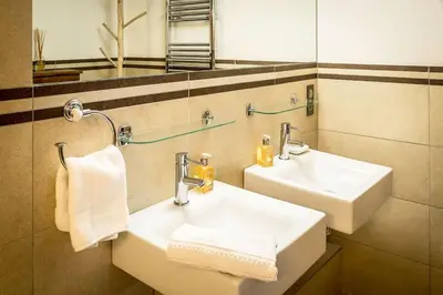 a bathroom with two white sinks and a mirror at Chalet Grand Cru in Chamonix-Mont-Blanc