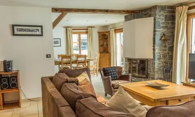 a living room with a couch and a table at Chalet Grand Cru in Chamonix-Mont-Blanc