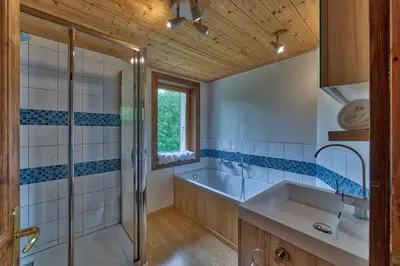 a bathroom with a shower and a sink and a tub at Chalet Heidi in Chamonix-Mont-Blanc