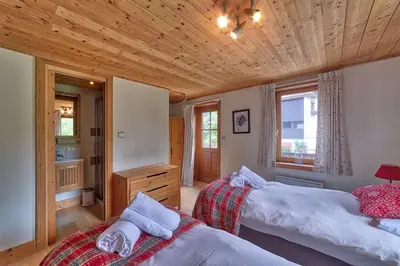 a bedroom with two beds and a wooden ceiling at Chalet Heidi in Chamonix-Mont-Blanc