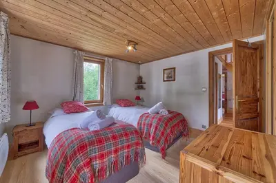 a bedroom with two beds and a wooden ceiling at Chalet Heidi in Chamonix-Mont-Blanc