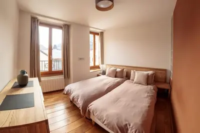 a bedroom with a large bed and a window at Paccard: Residence Le Lutetia in Chamonix-Mont-Blanc