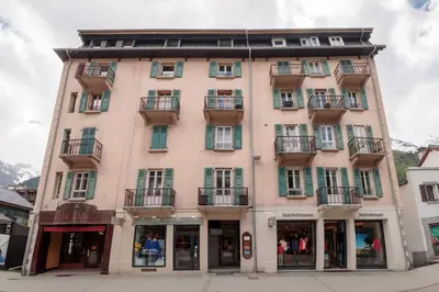 a tall building with windows and balconies on a street at Paccard: Residence Le Lutetia in Chamonix-Mont-Blanc