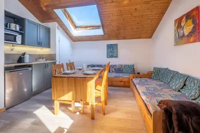 a kitchen and living room with a table and a couch at Skyhook: Batiment B in Chamonix-Mont-Blanc
