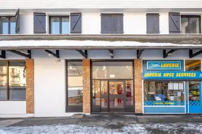 a store front of a building with snow on the ground at Skyhook: Batiment B in Chamonix-Mont-Blanc