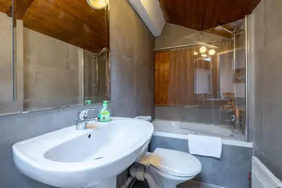 a bathroom with a sink and a toilet and a tub at Skyhook: Batiment B in Chamonix-Mont-Blanc