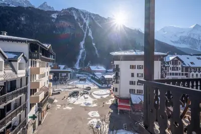 a view from a balcony of a town with a waterfall at Skyhook: Batiment B in Chamonix-Mont-Blanc