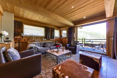 a living room with couches and a table at Chalet Noemie in Les Houches