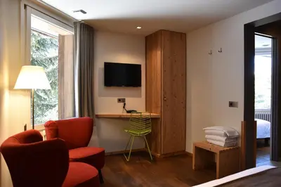 a bathroom with a shower and a bed and a sink at Hôtel LAPIAZ & Spa - FLAINE in Flaine