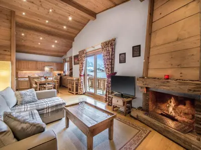 a living room with a couch and a fireplace at Appartement 3 chambres rénové à Megève - FR-1-453-6 in Megève