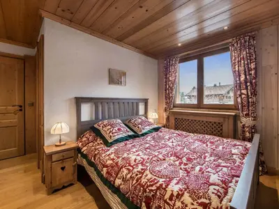 a bedroom with a large bed and a window at Appartement 3 chambres rénové à Megève - FR-1-453-6 in Megève