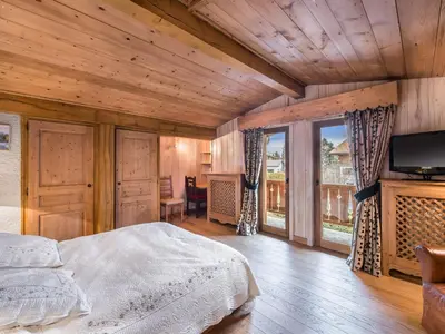 a bedroom with a bed and a large window at Appartement 3 chambres rénové à Megève - FR-1-453-6 in Megève