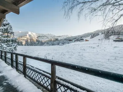 a view of a snow covered field behind a fence at Chalet 4 chambres à Megève Mont d'Arbois - 10 pers, terrasse, parking - FR-1-453-10 in Megève