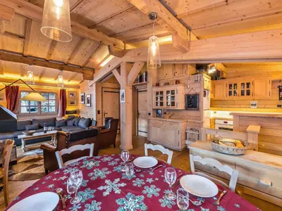 a dining room and living room in a log cabin at Chalet 4 chambres à Megève Mont d'Arbois - 10 pers, terrasse, parking - FR-1-453-10 in Megève
