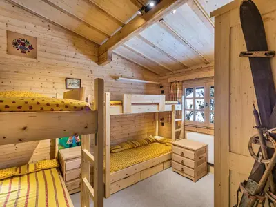 a bedroom with two bunk beds in a wooden cabin at Chalet 4 chambres à Megève Mont d'Arbois - 10 pers, terrasse, parking - FR-1-453-10 in Megève
