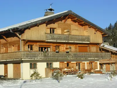 a large wooden house with a balcony in the snow at Appartement 4 chambres à Megève avec Wi-Fi et garage - FR-1-453-11 in Megève