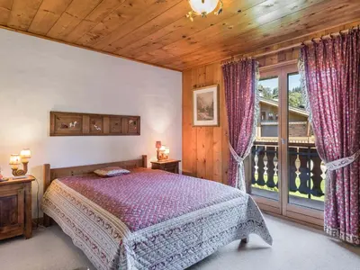 a bedroom with a bed and a large window at Appartement 4 chambres à Megève avec Wi-Fi et garage - FR-1-453-11 in Megève