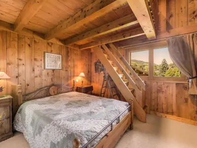 a bedroom with a bed in a log cabin at Appartement 4 chambres à Megève avec Wi-Fi et garage - FR-1-453-11 in Megève