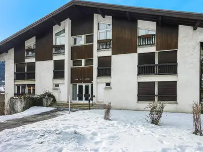 an apartment building with snow in front of it at Appartement confortable 3 chambres proche centre Megève, balcon, cheminée, 8 pers. - FR-1-453-14 in Megève