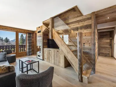 a living room with wooden walls and a staircase at Superbe duplex à Megève pour 7 pers., parking - FR-1-453-25 in Megève