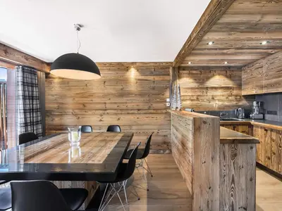 a dining room with a table and chairs at Superbe duplex à Megève pour 7 pers., parking - FR-1-453-25 in Megève