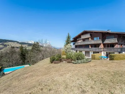 a large house on top of a hill with a pool at Superbe duplex à Megève pour 7 pers., parking - FR-1-453-25 in Megève