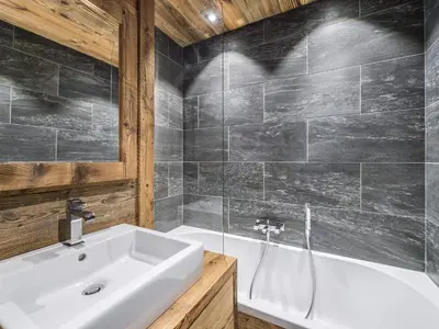 a bathroom with a white sink and a bath tub at Superbe duplex à Megève pour 7 pers., parking - FR-1-453-25 in Megève