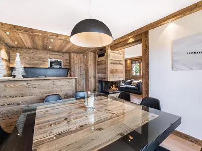 a dining room with a large wooden table and chairs at Superbe duplex à Megève pour 7 pers., parking - FR-1-453-25 in Megève