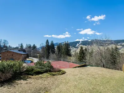 a house with a tennis court on a hill at Superbe duplex à Megève pour 7 pers., parking - FR-1-453-25 in Megève