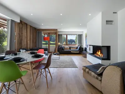 a living room with a table and a fireplace at Appartement duplex 2 ch., terrasse, proche pistes à Megève - FR-1-453-26 in Megève