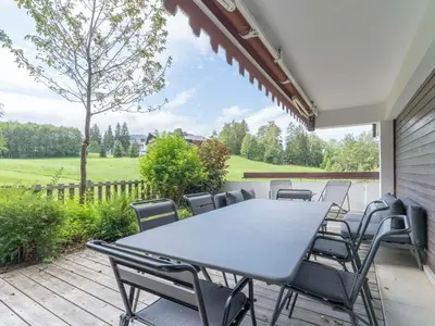a patio with a table and chairs on a deck at Appartement duplex 2 ch., terrasse, proche pistes à Megève - FR-1-453-26 in Megève