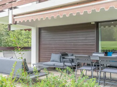 a patio with chairs and tables on a deck at Appartement duplex 2 ch., terrasse, proche pistes à Megève - FR-1-453-26 in Megève