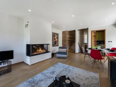 a living room with a fireplace and a dining room at Appartement duplex 2 ch., terrasse, proche pistes à Megève - FR-1-453-26 in Megève