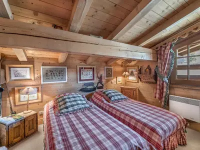 two beds in a room with wooden walls at Appartement 3 chambres Megève Sud avec Balcon et Wifi - FR-1-453-28 in Megève