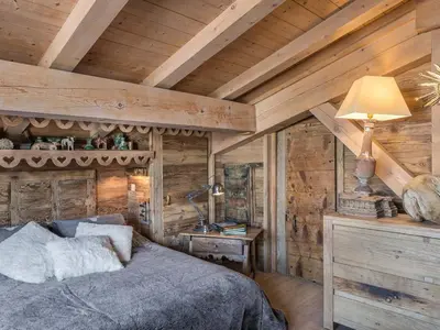 a bedroom with a bed in a room with wooden walls at Appartement 3 chambres Megève Sud avec Balcon et Wifi - FR-1-453-28 in Megève