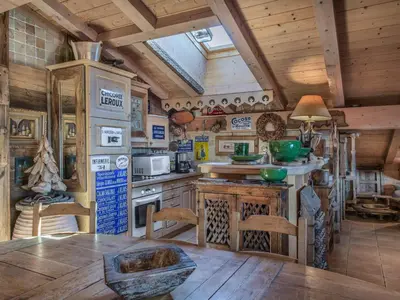 a kitchen with a table and chairs in a cabin at Appartement 3 chambres Megève Sud avec Balcon et Wifi - FR-1-453-28 in Megève