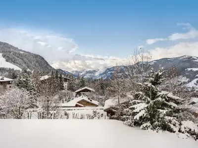 a snow covered yard with a house and mountains at Appartement 2 Chambres à Megève, Proche Pistes, WiFi - FR-1-453-32 in Megève