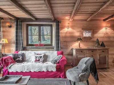 a living room with a red couch in a cabin at Bel Appartement 3 Chambres à Megève, Terrasse, Wifi - FR-1-453-35 in Megève