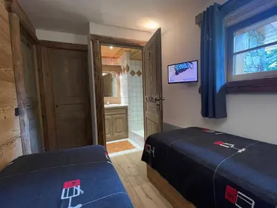 a bedroom with a bed and a bathroom with a window at Bel Appartement 3 Chambres à Megève, Terrasse, Wifi - FR-1-453-35 in Megève