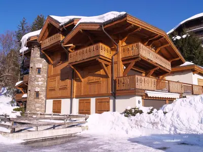 a large wooden building with snow around it at Bel Appartement 3 Chambres à Megève, Terrasse, Wifi - FR-1-453-35 in Megève