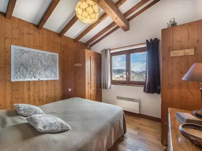 a bedroom with a bed in a room with wooden walls at Appartement 3 pièces Megève - Animaux admis, Parking inclus - FR-1-453-38 in Megève