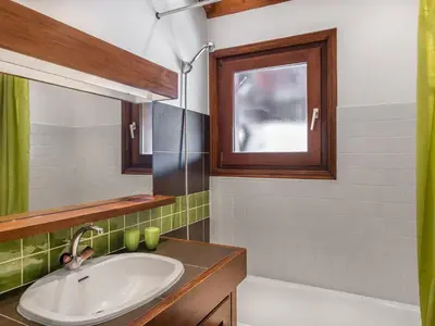 a bathroom with a sink and a mirror and a tub at Appartement 3 pièces Megève - Animaux admis, Parking inclus - FR-1-453-38 in Megève