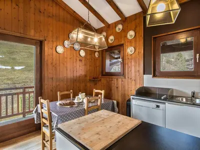 a kitchen with a table and a dining room at Appartement 3 pièces Megève - Animaux admis, Parking inclus - FR-1-453-38 in Megève