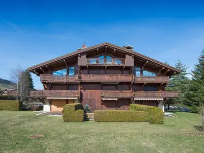 a large wooden house with a tree in front of it at Appartement 3 pièces Megève avec Balcon et Garage - FR-1-453-45 in Megève