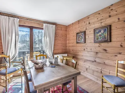 a dining room with wooden walls and a table and chairs at Appartement cosy 2 chambres avec wifi à Megève - FR-1-453-48 in Megève